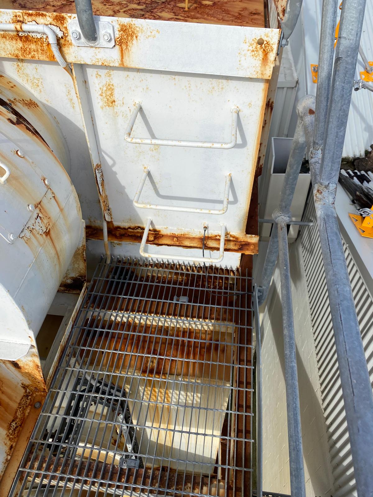 Corroded grating and access platform before restoration